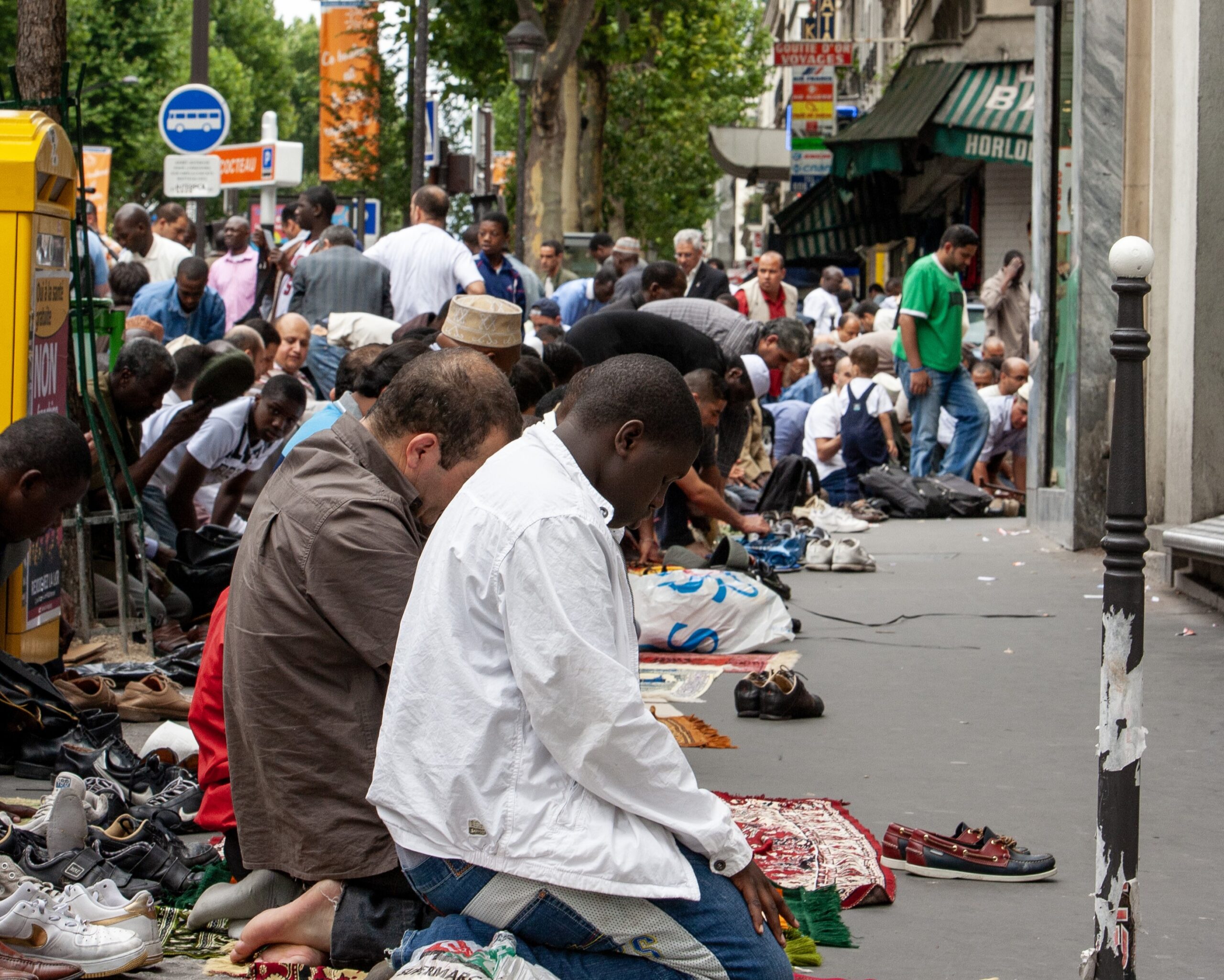 Pausing for Friday noon prayers, Muslims line the sidewalks near a mosque in Paris. IMB Photo